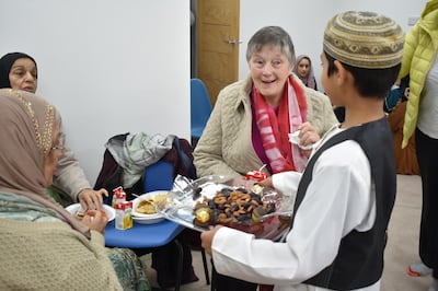 A boy hands out treats to visitors at Stornoway mosque. Claire Corkery/ The National