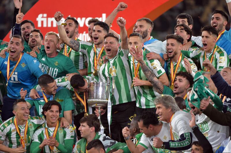 Real Betis players celebrate with the Copa del Rey after winning the trophy. AFP