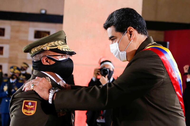 Venezuela's President Nicolas Maduro and Interior Minister Nestor Reverol greet each other during Venezuela's Bolivarian National Guard anniversary ceremony, amid the outbreak of the coronavirus disease (COVID-19), in Caracas, Venezuela August 4, 2020. Miraflores Palace/Handout via REUTERS ATTENTION EDITORS - THIS PICTURE WAS PROVIDED BY A THIRD PARTY.
