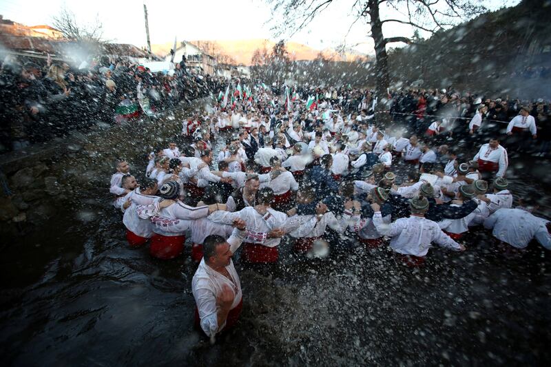 Men sing and dance in the waters of the Tundzha river to celebrate Epiphany Day in Kalofer, Bulgaria. Reuters