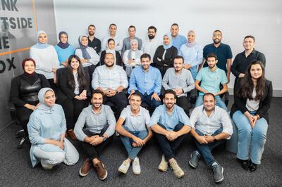 Sideup founder Waleed Rashed, seated, fourth from left, with team members. Photo: Sideup