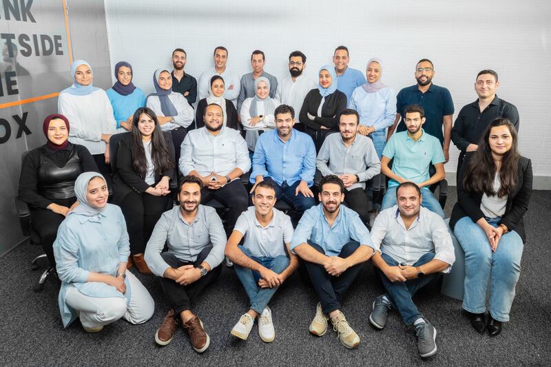 Waleed Rashed, founder and chief executive of Sideup start-up (seated on chair, fourth from left), with team members. Photo: Sideup