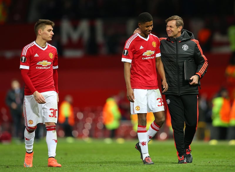 MANCHESTER, ENGLAND - FEBRUARY 25:  Marcus Rashford (C) of Manchester United is congratulated by goalkeeping coach Frans Hoek (R) after the UEFA Europa League Round of 32 second leg match between Manchester United and FC Midtjylland at Old Trafford on February 25, 2016 in Manchester, United Kingdom.  (Photo by Alex Livesey/Getty Images)