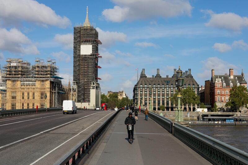 Commuters cross Westminster Bridge in view of the Houses of Parliament and Elizabeth Tower, also known as Big Ben, in London, U.K., on Monday, May 11, 2020. U.K. Prime Minister Boris Johnson will flesh out his plan for lifting the U.K. lockdown in Parliament as he seeks to get more people back to work, even as resistance from politicians and labor unions laid bare the hurdles facing the government as it tries to kickstart the economy. Photographer: Jason Alden/Bloomberg