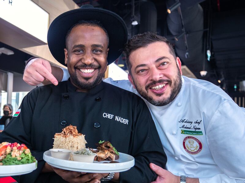 Chef Nader Al Aisari (centre) was one of many regional chefs to cook at Expo 2020 Dubai. Seen here with Qatar's Mohammad Najem. Victor Besa / The National