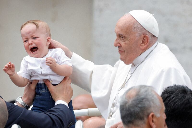Pope Francis blesses a child in St Peter's Square at the Vatican. Reuters