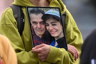 A protester in Berlin holds a picture of Iranian-German Jamshid Sharmahd with his daughter Gazelle on July 31. AFP