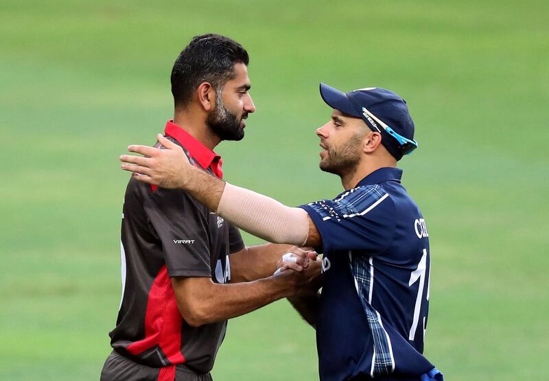 Dubai, United Arab Emirates - October 30, 2019: UAE's Ahmed Raza and Scotland's Kyle Coetzer after the game between the UAE and Scotland in the World Cup Qualifier in the Dubai International Cricket Stadium. Wednesday the 30th of October 2019. Sports City, Dubai. Chris Whiteoak / The National