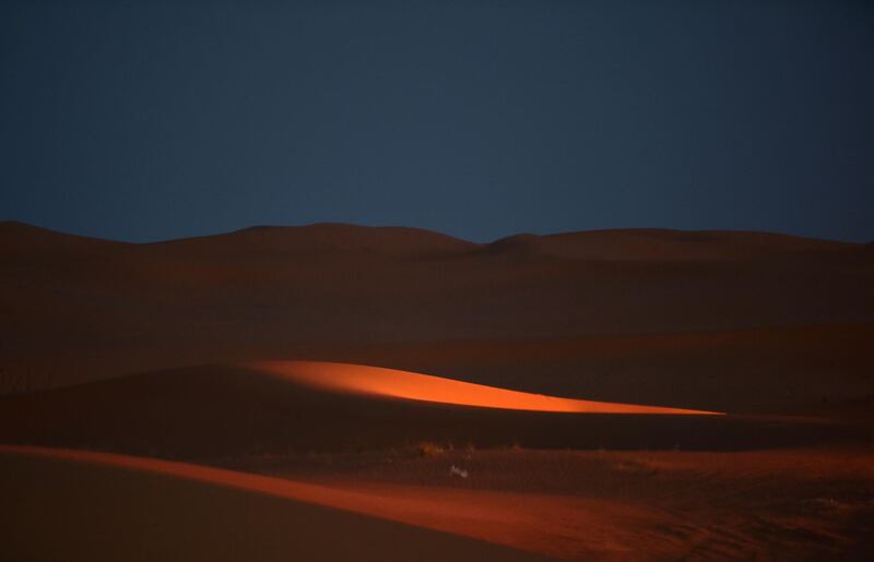 Light reflects on rolling dunes surrounding the "Riyadh Oasis." AFP