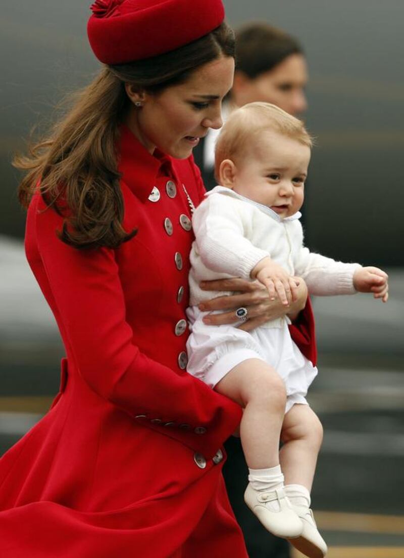 Catherine, the Duchess of Cambridge, holds her son Prince George after disembarking their plane. Reuters / Phil Noble