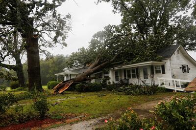 A downed tree rests on a house during the passing of Hurricane Florence in the town of Wilson, North Carolina, U.S. September 14, 2018. REUTERS/Eduardo Munoz