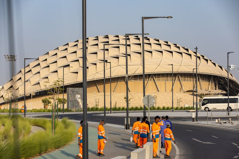 Workers outside the metro station serving the Al Thumama Stadium in Doha. Bloomberg