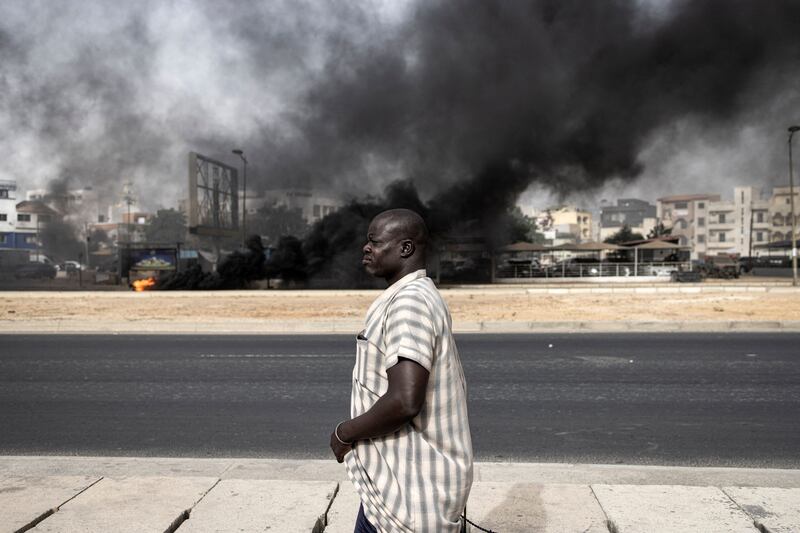 Smoke rises in Dakar as protests continue over the arrest of opposition leader Ousmane Sonko before the final verdict in his rape trial. AFP
