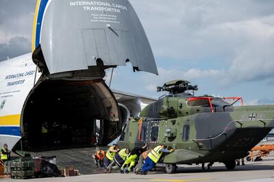 LEIPZIG, GERMANY - MAY 18: Soldiers of the Bundeswehr, Germany's armed forces, unload an NH90 transport helicopter from a plane Antonov AN-124 for military transport arriving from Afghanistan at Leizpig Airport on May 18, 2021 in Leipzig, Germany. Germany has begun pulling out its approximately 1,100 remaining troops from Afghanistan in accordance with the general withdrawal of NATO forces. A total of 53 Bundeswehr soldiers have been killed in Afghanistan since 2002.  (Photo by Jens Schlueter/Getty Images)