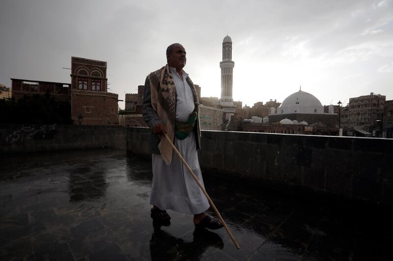 epa09131593 A Yemeni walks past a mosque on the eve of the Muslim fasting month of Ramadan in the old city of Sana'a, Yemen, 12 April 2021. Muslims around the world celebrate the holy month of Ramadan by praying during the night time and abstaining from eating, drinking, and sexual acts during the period between sunrise and sunset. Ramadan is the ninth month in the Islamic calendar and it is believed that the revelation of the first verse in Koran was during its last 10 nights.  EPA/YAHYA ARHAB