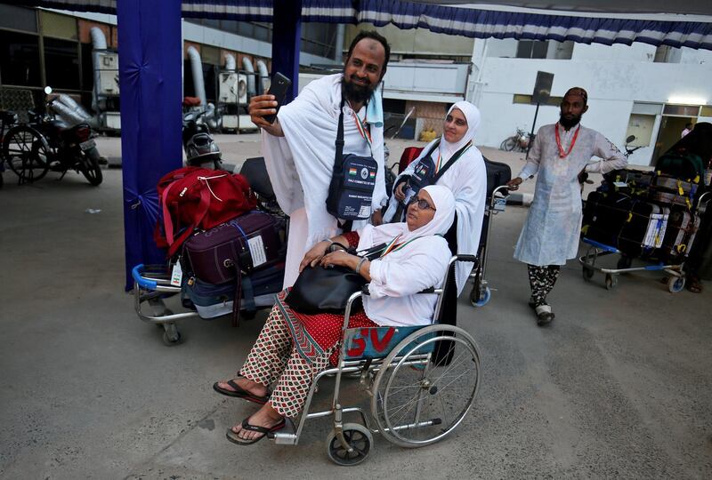 Hajj pilgrims take a selfie before leaving for the annual hajj pilgrimage to the holy city of Makkah, at the airport in Ahmedabad, India, August 1, 2018. Reuters