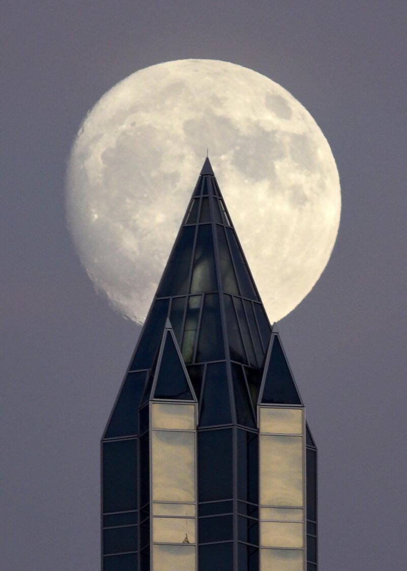 December's nearly full moon, known as the Cold Moon, rises over One PPG Place Downtown Pittsburgh. Bob Donaldson / Pittsburgh Post-Gazette via AP