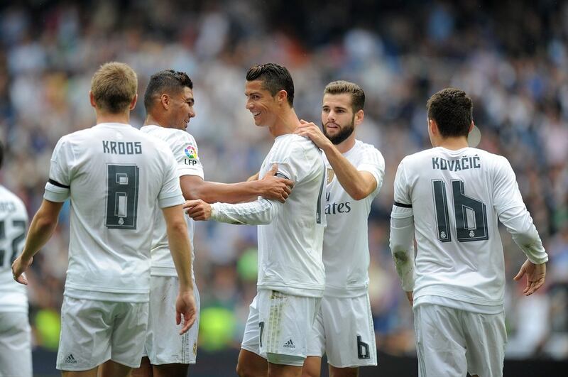 Cristiano Ronaldo is congratulated by teammates after scoring the goal that made him Real Madrid's leading all-time scorer. Denis Doyle / Getty Images