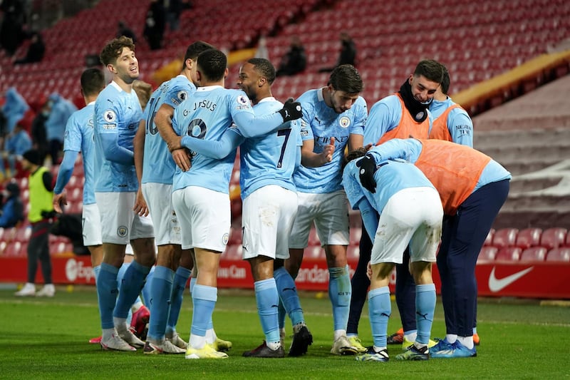 LIVERPOOL, ENGLAND - FEBRUARY 07: Raheem Sterling of Manchester City celebrates with team mates after scoring their side's third goal during the Premier League match between Liverpool and Manchester City at Anfield on February 07, 2021 in Liverpool, England. Sporting stadiums around the UK remain under strict restrictions due to the Coronavirus Pandemic as Government social distancing laws prohibit fans inside venues resulting in games being played behind closed doors (Photo by Jon Super - Pool/Getty Images)