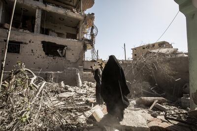 RAQQA, SYRIA - 2017/10/08: Civilians walks up through city ruins while fleeing fighting in Islamic state controlled area. More than a thousand dead and a city in ruins.
The Syrian civil war has been carried on for more than 6 years and it has caused more than 450,000 deaths and over 5 million people has made to become refugees. There is still no ending to this conflict in sight. (Photo by Afshin Ismaeli/SOPA Images/LightRocket via Getty Images)