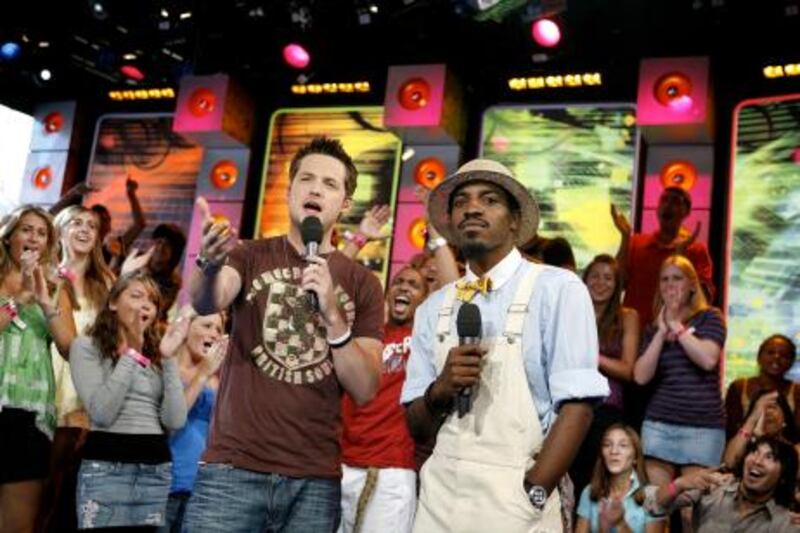 VJ Damien Fahey, left, and rapper Andre Benjamin, of Outkast, appear onstage during MTV's "Total Request Live" at the MTV Times Square Studios Tuesday, Aug. 8, 2006 in New York. Benjamin stars in the new movie "Idlewild" which premieres Aug. 25, 2006.  (AP Photo/Jason DeCrow)