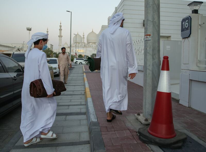 Worshippers arrive at Ibn Taymiyyah Mosque in Abu Dhabi for Friday evening prayers. Three days of official mourning for President Sheikh Khalifa begin on Saturday. Victor Besa / The National.