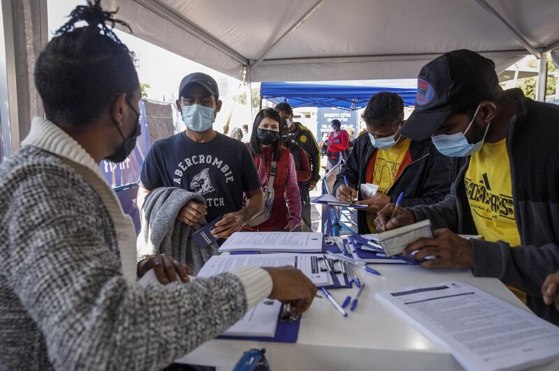 Foreign nationals and asylum seekers queue to register their details for the Pfizer-BioNTech Covid-19 vaccine at a vaccination centre in Tel Aviv. Bloomberg