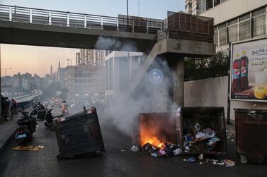 Anti-government protesters burn bins to block a highway that leads to the airport during a protest near Beirut. EPA