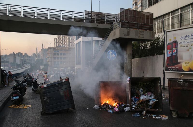 epa09304077 Anti-government protesters burn waste bins to block a highway that leads to the airport during a protest in Beirut, Lebanon, 26 June 2021. Anti-government protesters closed the streets with garbage bins and burning tires, to protest against power cuts, high cost of living, low purchasing power of the Lebanese pound, as well as the failure of political leaders to form a government after months of deadlock. State-provided electricity in Beirut has reached record-low levels that seem insurmountable for financial reasons.  EPA/NABIL MOUNZER