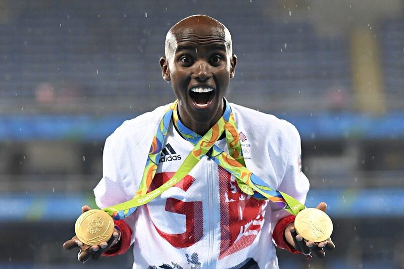 Gold medallist Mo Farah celebrating near the podium for the Men's 5000m during the athletics event at the Rio 2016 Olympic Games. AFP