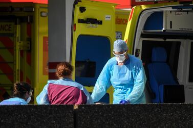 Doctors wearing protective equipment are seen loading a patient in to an ambulance outside St Thomas' Hospital on April 7, 2020 in London. Getty Images