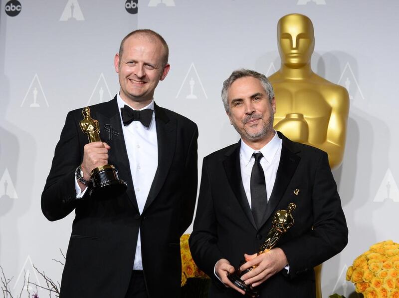 Alfonso Cuaron, right, and Mark Sanger pose in the press room with the award for best film editing for Gravity during the Oscars at the Dolby Theatre on March 2, 2014, in Los Angeles. Jordan Strauss / Invision / AP