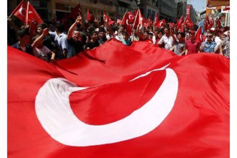 Demonstrators shout slogans against the outlawed Kurdistan Workers Party (PKK) during a demonstration in Istanbul on Sunday after Kurdish fighters killed 13 Turkish soldiers in the worst clash since the PKK ended a ceasefire in February.