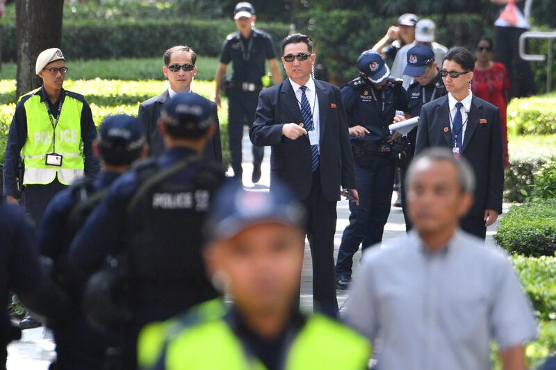 North Korean security personnel keep watch outside the St Regis hotel, where North Korean leader Kim Jong-un is staying. Ted Aljibe / AFP