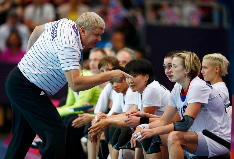 Russia's coach Evgeny Trefilov talks to his team in their women's handball Preliminaries Group A match against Montenegro at the Copper Box venue during the London 2012 Olympic Games August 5, 2012. REUTERS/Marko Djurica (BRITAIN  - Tags: SPORT HANDBALL OLYMPICS)  