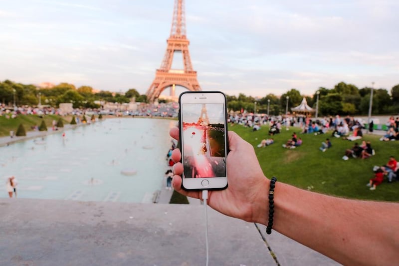 A man tries to catch a Pokemon Go character at the Trocadéro, in front of the Eiffel Tower, in Paris. The augmented-reality game ties collectable fantasy creatures to mobile-phone maps. Edward Berthelot / Getty Images