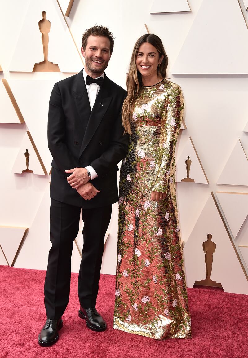 Jamie Dornan and Amelia Warner, wearing gold Giambattista Valli. AP