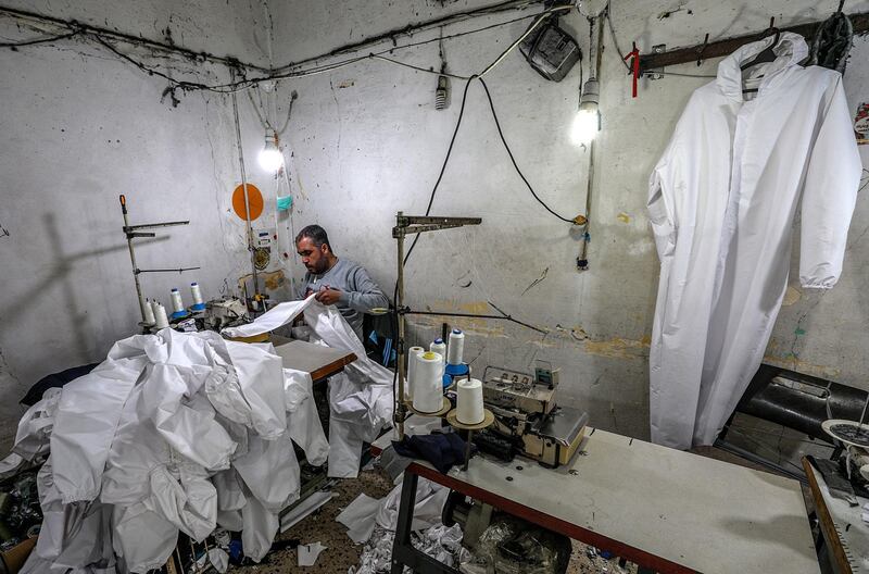 Palestinians manufacture protective coverall suits in a small sewing factory in Gaza City.  EPA