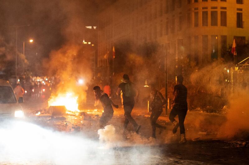 Riot police fired tear gas to disperse demonstrators. AP