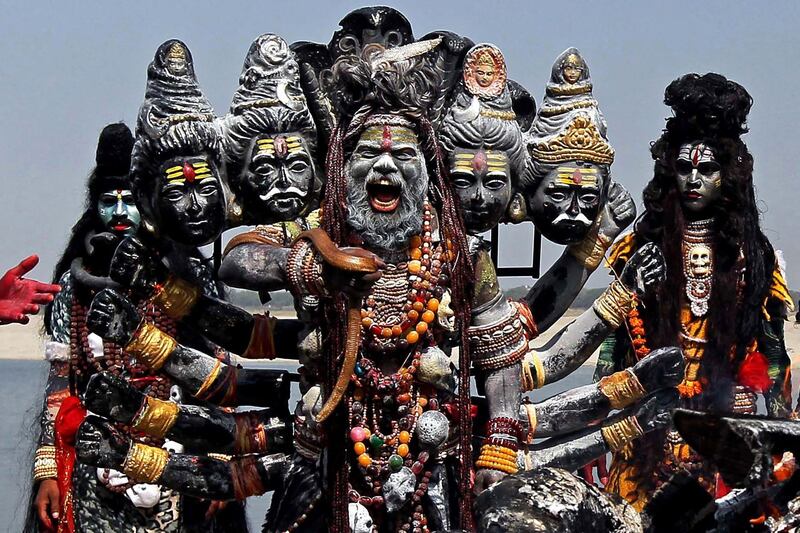 Devotees dressed as Hindu gods prepare to participate in a religious procession from a crematorium on the banks of the Ganges river in Varanasi, India. AFP