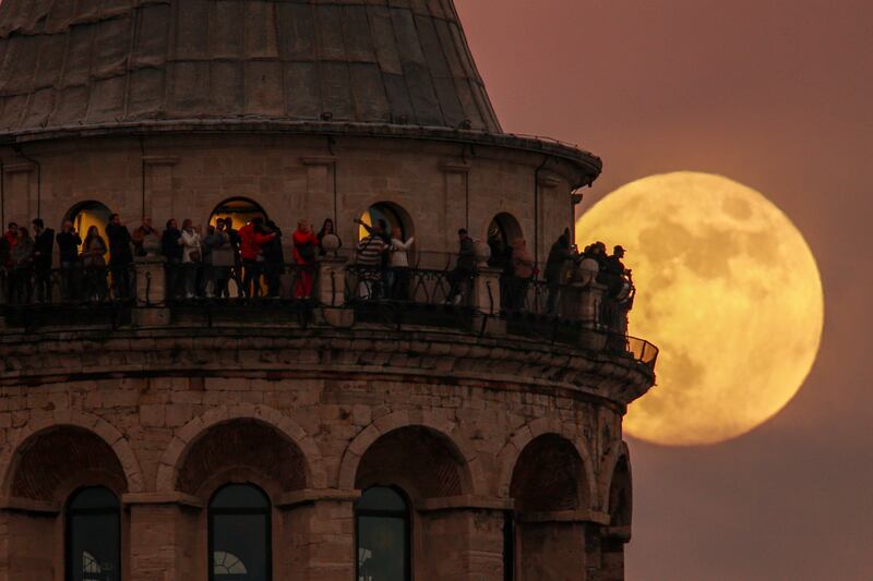 The last full moon of the year, known as the Cold Moon, rises behind the Galata Tower in Istanbul, Turkey. AP