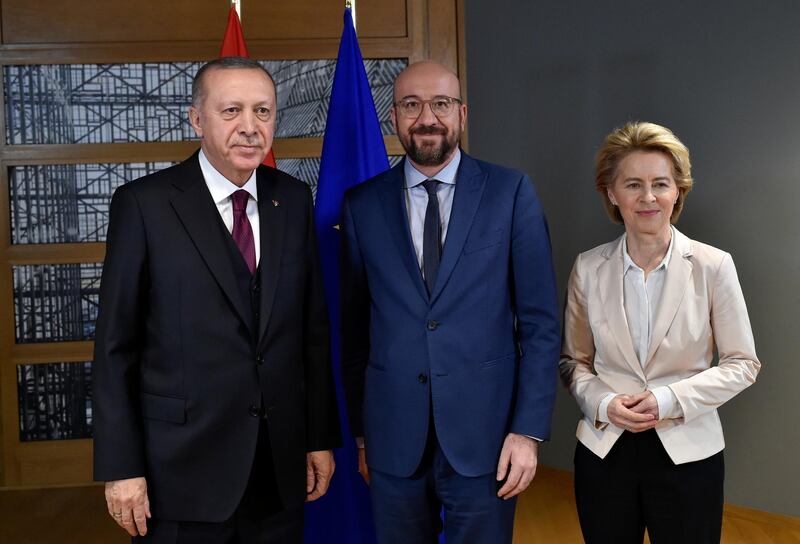 EU Council President Charles Michel (C) and European Commission President Ursula von der Leyen (R) pose with Turkish President Erdogan (L) before their meeting in Brussels.  Reuters