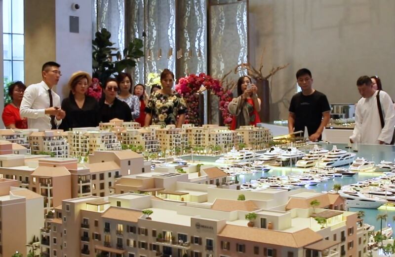 Chinese investors, pictured inspecting models of properties in Dubai during a 2018 trip, are returning in bigger numbers this year, estate agents and analysts say. Photo: Driven Properties