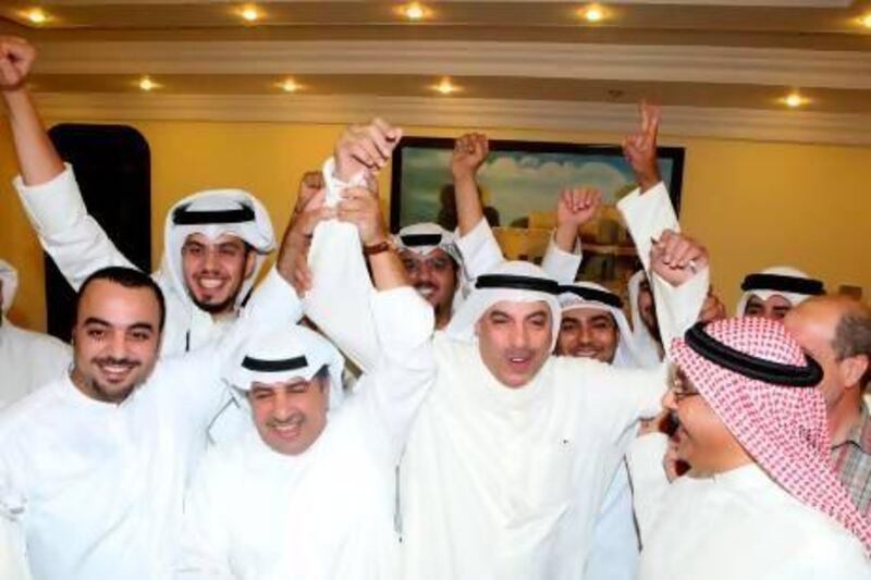 Faisal Al Shayaa, centre, celebrates with his supporters following his victory in the parliamentary elections in Kuwait City. Yasser Al Zayyat / AFP