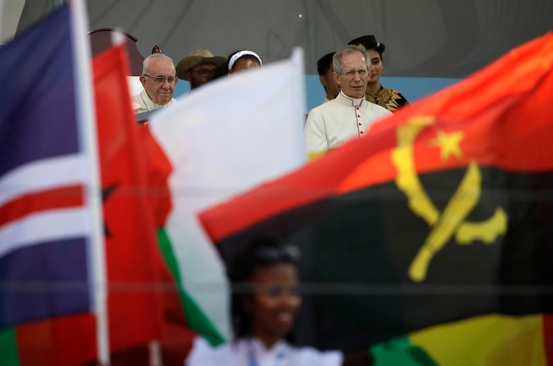 Pope Francis, flanked at right by Master of Ceremonies Bishop Guido Marini, looks at flags during a performance at the World Youth Day welcome ceremony at Campo Santa Maria La Antigua in Panama City, Thursday, Jan. 24, 2019. (AP Photo/Alessandra Tarantino)