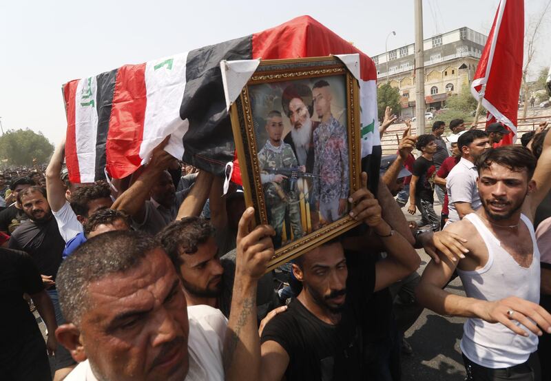 Iraqi protesters carry the coffin of Yasser Makki. AFP