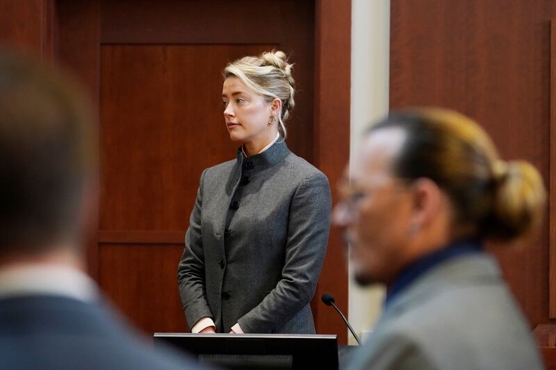 Heard and Depp watch as the jury comes into the courtroom. AP