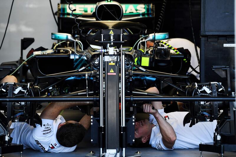 Mechanics work in the garage of Mercedes driver Lewis Hamilton ahead of the Formula One Azerbaijan Grand Prix in Baku on April 26, 2018. Kirill Kudyavtsev / AFP Photo