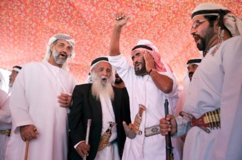 Ras Al Khaimah, United Arab Emirates, Feb 09, 2013 -  Habus men, including Rashed Mohammed, second from right, perform the Nadbah, a traditional war cry now reserved for cemonies,  during a welcoming ceremony for Ruth Ash by members of hanus and shehhuh mountain tribes at wadi qada'a. Doctora Mariam ran the first hospital in RAK and did community outreach programs from 1966-77, under protection of tribal rulers. ( Jaime Puebla / The National Newspaper ) 