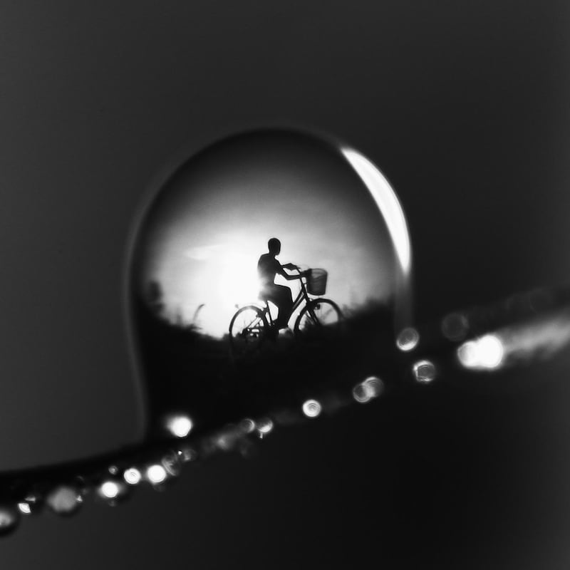 Wahyu Budiyanto who won with photograph of a water droplet reflection of a man on a bicycle Courtesy Hipa